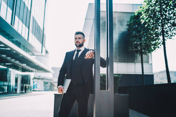 istock Confident businessman leaning on pillar 1445520312