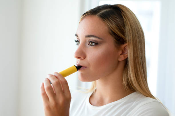 istock Woman smokes disposable vape 1445521647