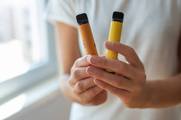 Electronic cigarette in a woman's hand stock photo