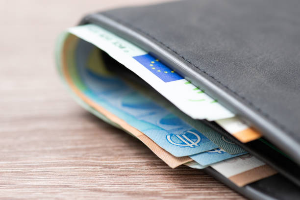 EU money in grey leather wallet close up on wooden table stock photo