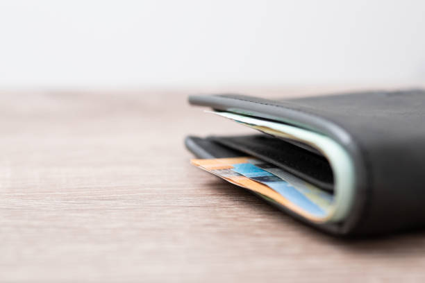 istock Euro bills in wallet on the table, close up, copy space on the left 1445521935