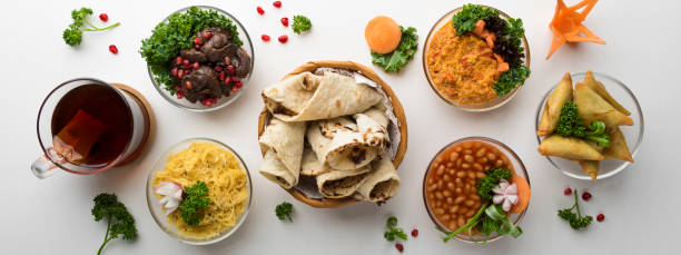 istock Traditional Arabic breakfast with hummus, olive, beans, bread, samosa and coffee isolated on table top view of arabian food 1445525668
