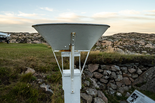Lindesnes, Norway - August 05 2022: A classic rain gauge used for measuring rain.