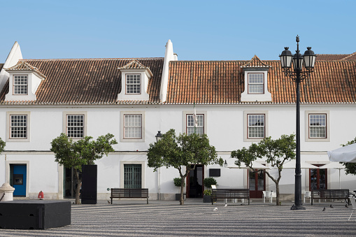 Typical buildings in the Pombaline style in the main square of Vila Real de Santo Antonio in the Algarve province of Portugal. This historic town on the border with Spain was re-built after the 1755 earthquake that devastated huge swaths of Portugal. The Pombaline style is named after the Marquis of Pombal who oriented the re-building of Lisbon and other cities destroyed by the earthquake and accompanying tsunami.