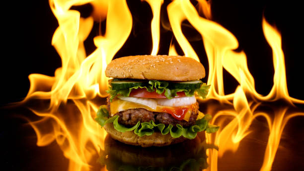 istock Delicious burger on the background of fire 1445526347
