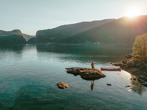 Scenic aerial  view of young man  setting  canoe on the lake in Norway