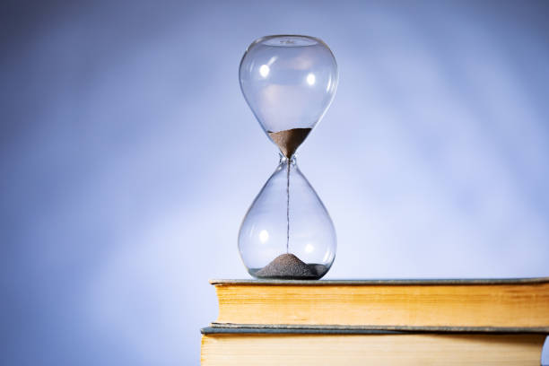 istock Hourglass and books 1445527978