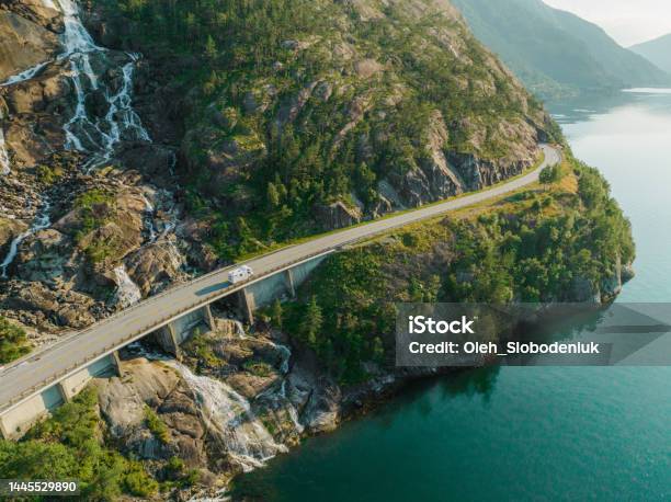 Aerial View Of Road Near Waterfall That Falls Into Fjord In Norway Stock Photo - Download Image Now