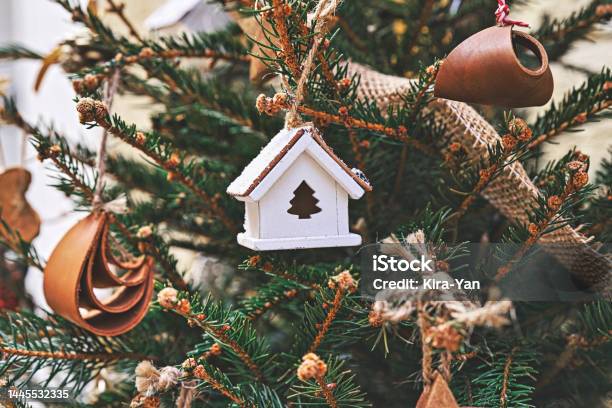 Vintage Wooden Toy House On Christmas Tree Natural Xmas Ornaments For Christmas Tree Zerowaste Stock Photo - Download Image Now