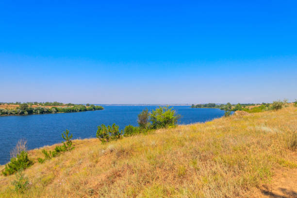 istock Summer landscape with beautiful river, green trees and blue sky 1445534815