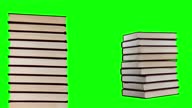 istock Growing pile of books on a green background, stop motion animation. Learning, wisdom, library concept. Green screen background. 1445537681