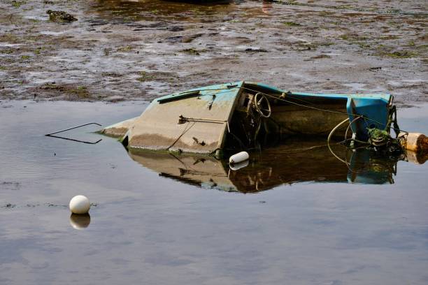 istock small fishing boat that has sunk in the harbor basin 1445540794