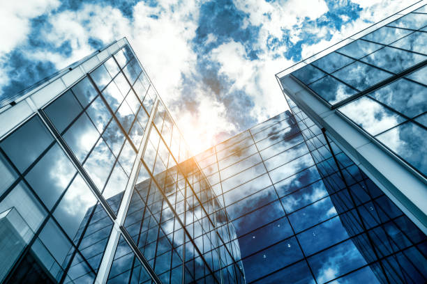 istock low angle view of a contemporary glass skyscraper reflecting the blue sky 1445548535