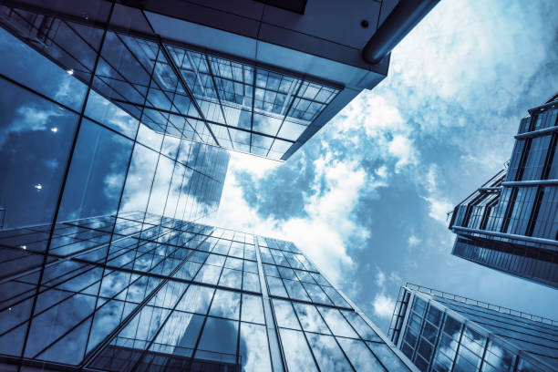istock low angle view of a contemporary glass skyscraper reflecting the blue sky 1445548553