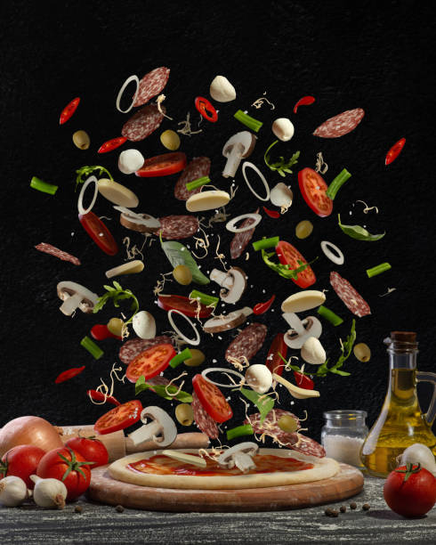 istock Cooking pizza. levitating ingredients on black background 1445551097