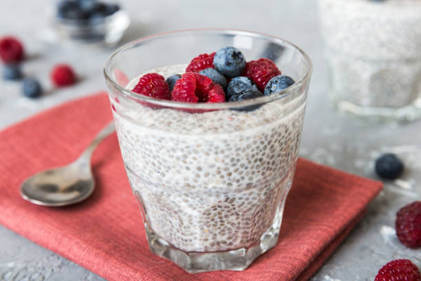 istock Healthy breakfast or morning with chia seeds vanilla pudding raspberry and blueberry berries on table background, vegetarian food, diet and health concept. Chia pudding with raspberry and blueberry 1445551152