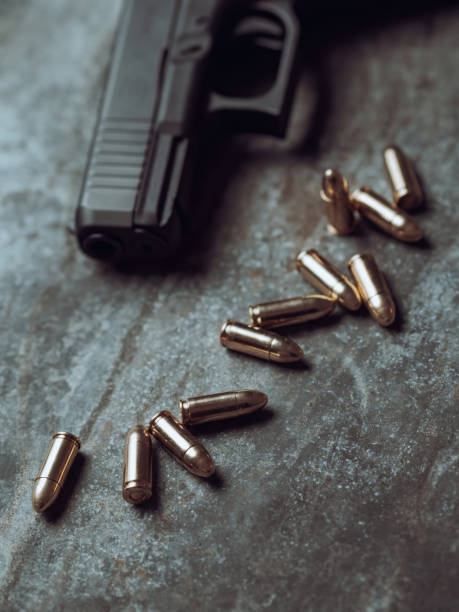 istock Hand gun with ammunition on dark background. 9 mm pistol. 1445552974