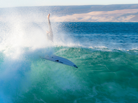 Crashing surfer in wave