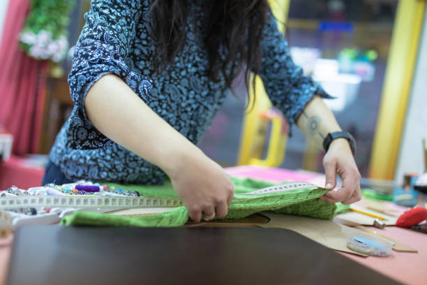 istock Female tailor taking measurements 1445555434