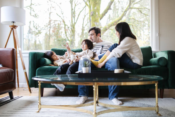 istock Family Relaxes At Home Together on Sofa 1445556907