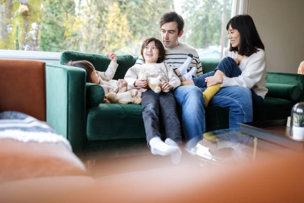 istock Family Relaxes At Home Together on Sofa 1445556921