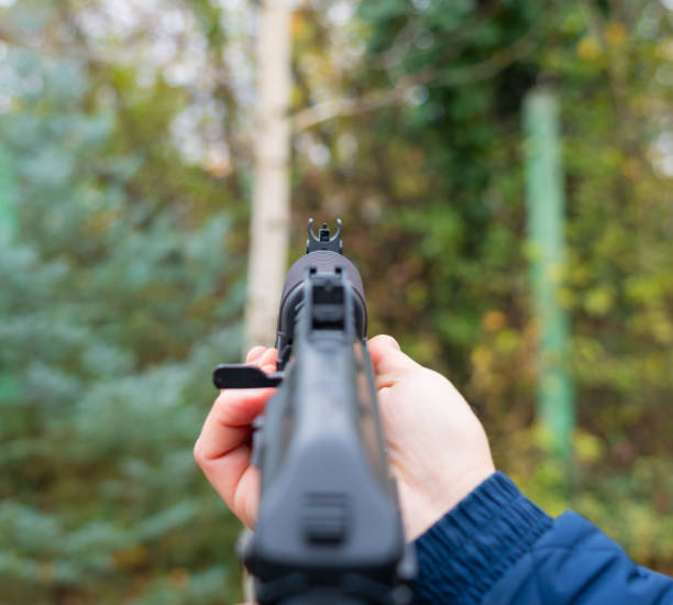 istock Male hand holds a Kalashnikov assault rifle first-person view 1445557324
