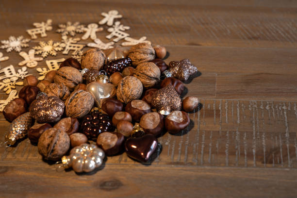 Different types of nuts and Christmas tree decorations are arranged on the table, copy space. High quality photo