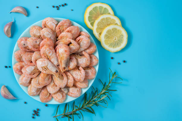 istock shrimp boiled in a plate with spices on a blue background 1445558741