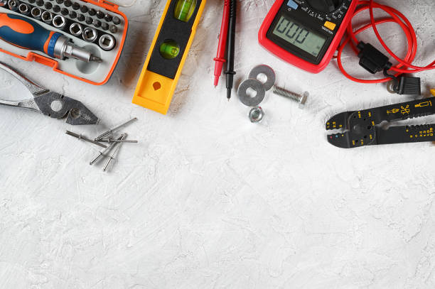 Set of hand tools on white plaster background. Work tools for electrician, carpenter, mechanic, plumber and hobbist. Top view, space for text, flat lay. Commonly used tools for home maintenance work. electrician multimeter stock pictures, royalty-free photos & images