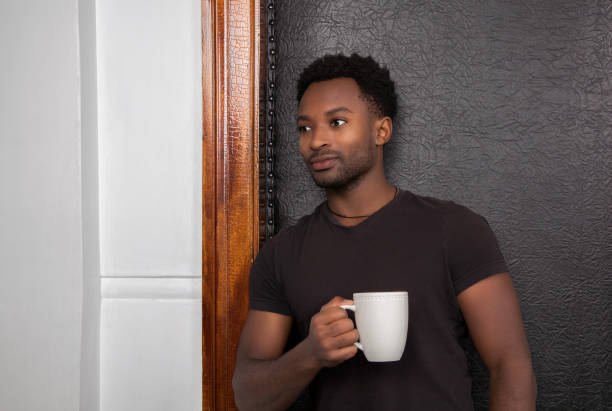 istock dreamy man drinking coffee cup leaning on door wood frame and black leather 1445561343