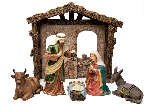 Old figurines representing a Nativity scene (the holy family) donkey and an ox