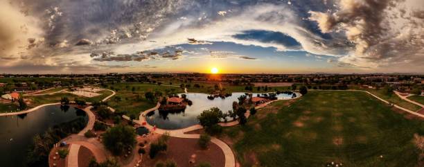 Sunset Over The Park Aerial panoramic image of a sunset over Discovery Park in Gilbert, Arizona, during a warm summer evening. tempe arizona stock pictures, royalty-free photos & images