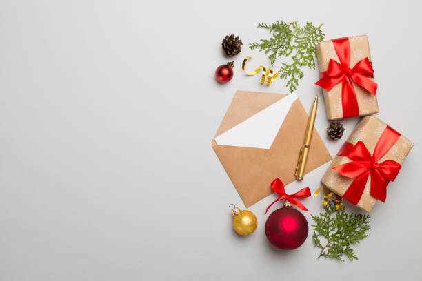istock Craft envelope with christmas decoration on color background, top view 1445564772