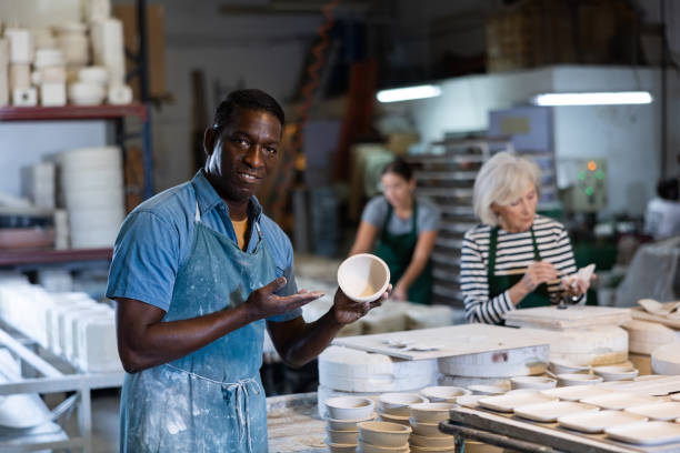 istock Portrait of positive man potter in workshop 1445566361