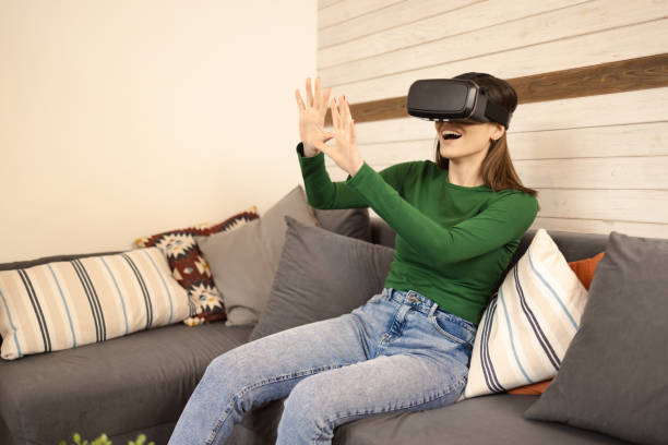 istock Young woman wearing VR glasses 1445568486