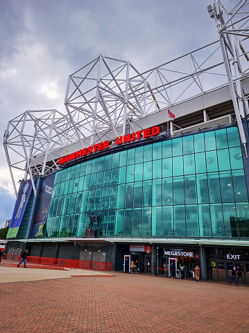 Manchester, UK - September 29, 2022: Old Trafford football stadium, the famous home of Manchester United, one of the most recognised global brands in sport.
