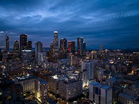 Aerial view of Downtown Los Angeles at dusk, looking across the historic core towards skyscrapers in the financial district.