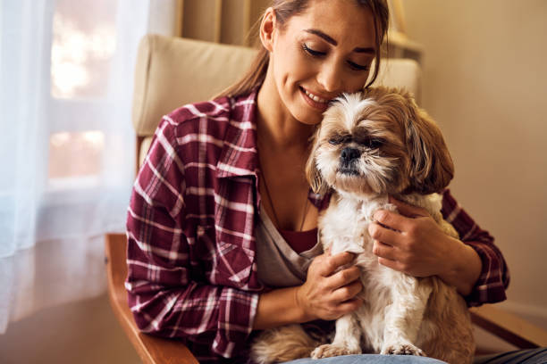 istock Affectionate woman embracing her dog at home. 1445574863