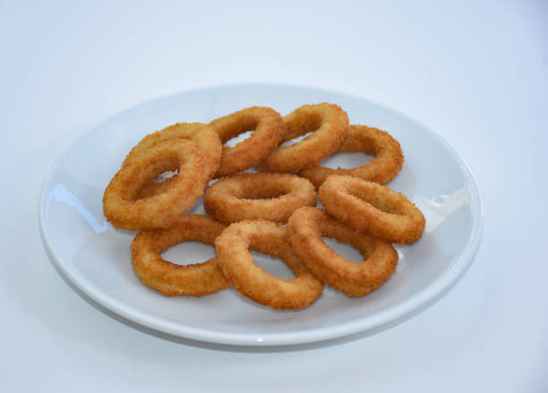 istock fried onion rings on white plate, isolated on white background 1445575007