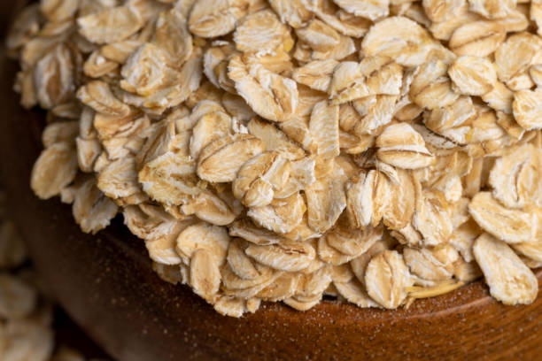 istock Oat flakes poured into a wooden bowl 1445576723