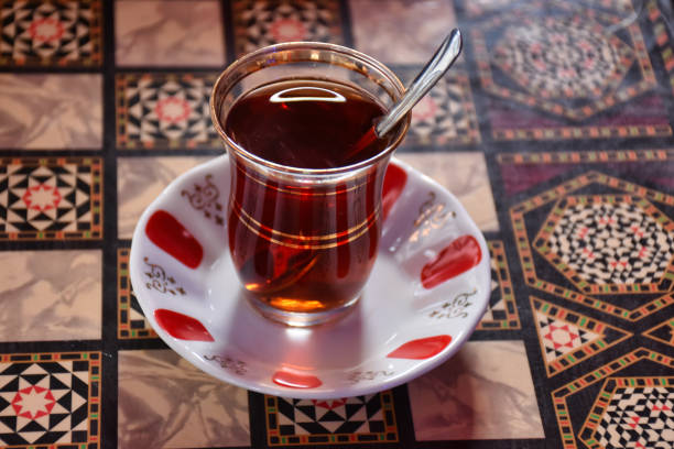 istock Turkish tea in a traditional glass cup with a spoon is standing on the backgammon table 1445577040