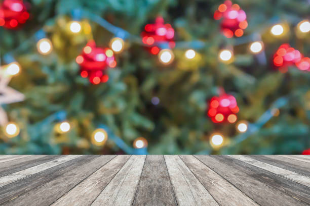 istock Empty wood table top with blur Christmas tree with bokeh light background 1445579158