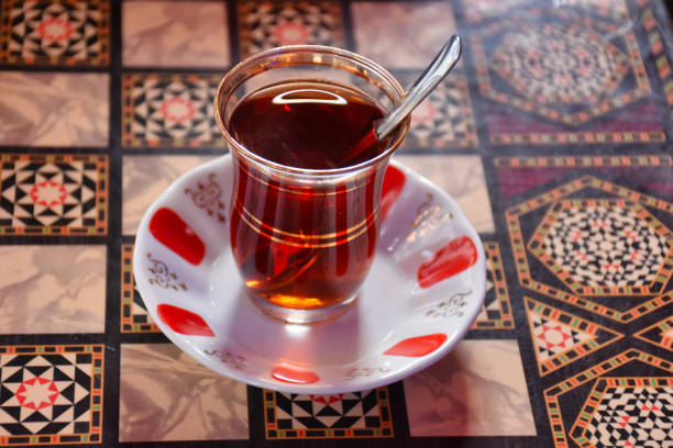 istock Turkish tea in a traditional glass cup with a spoon is standing on the backgammon table 1445579881