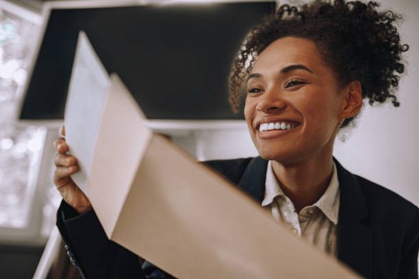istock Close up mulatta woman opening envelope with letter 1445580046