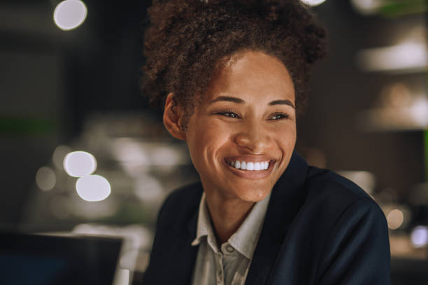 istock Smiling mulatta woman looking aside in office 1445580090