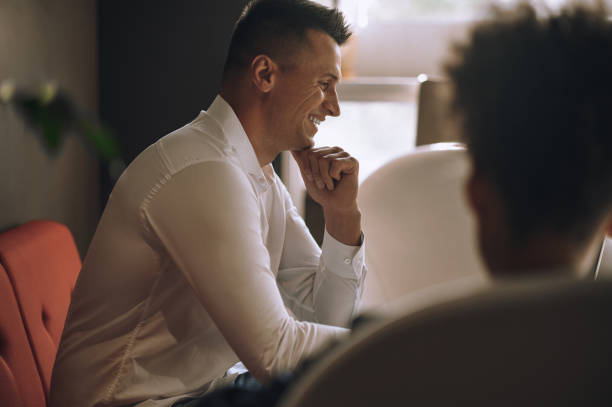 istock Man sitting sideways to camera in office 1445580162