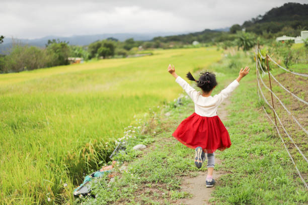 a Asian girl is running in the farm.