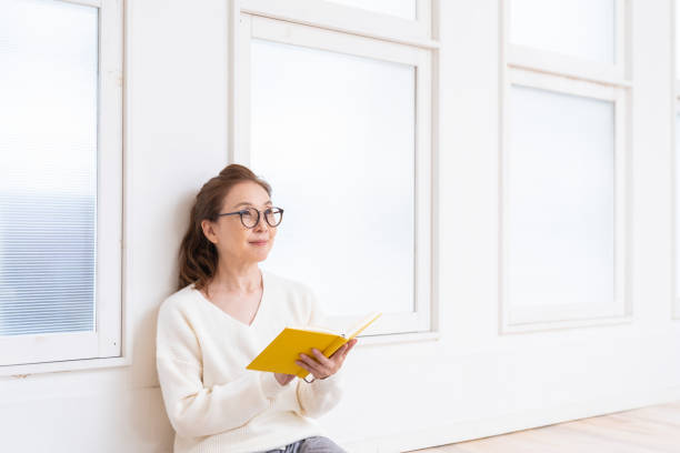 istock senior age woman who reads a book 1445581701