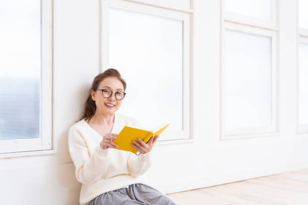 istock senior age woman who reads a book 1445581717