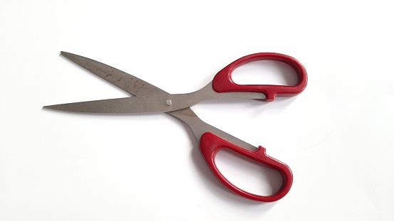 red scissors isolation on a white background with a little warm color